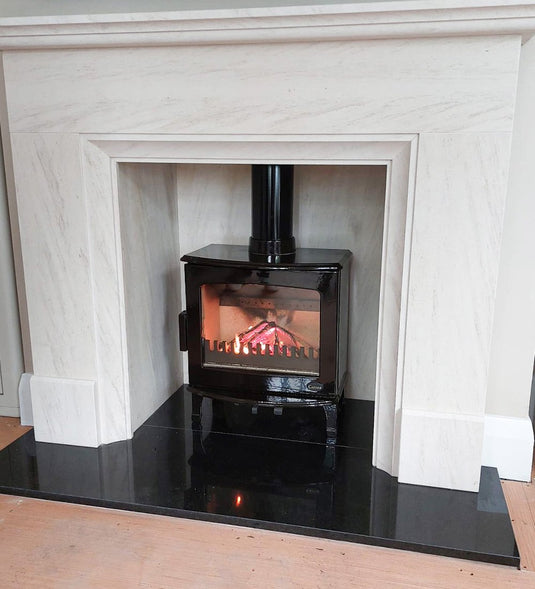 Carron 5Kw Black Enamel Wood Burning Ecodesign Stove installed in a living room